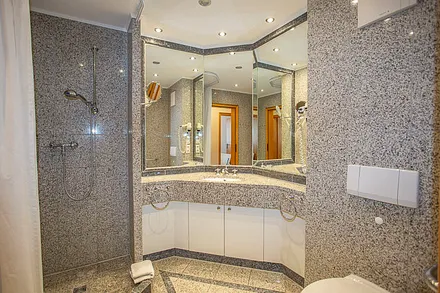 Großes geräumiges Bad im Granitstil mit großem Spiegelpanorama