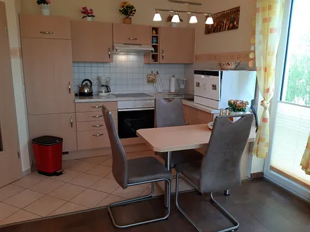 offene Küche mit Essplatz und Geschirrspüler, Toaster, Kaffeemaschine, Wasserkocher