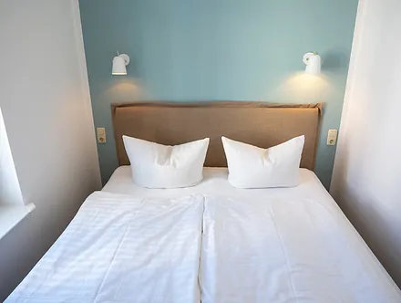 Das klitzekleine Schlafzimmer mit Doppelbett.