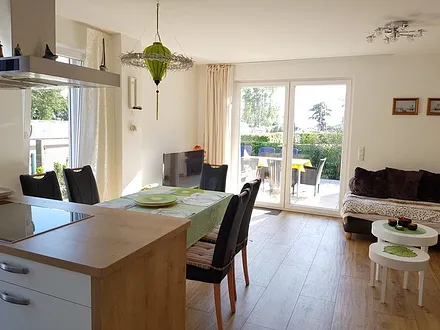 Heller Wohn- und Essbereich mit hochwertiger Küche. Die offene Küche ist komplett ausgestattet.