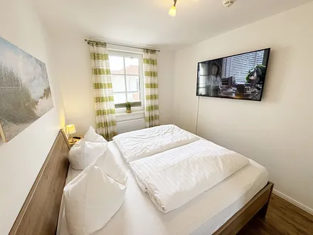 1. Schlafzimmer mit Doppelbett und Smart-TV