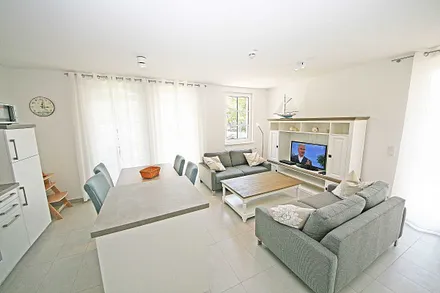 Wohnbereich mit 2 Couchen, Leselampe, Smart-TV, Blu-Ray-Player und eine Musikanlage mit DAB-Radio