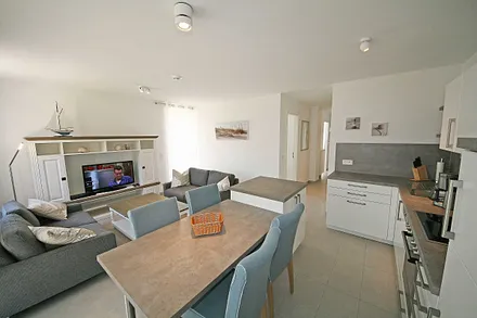 Wohnbereich mit 2 Couchen, Leselampe, Smart-TV, Blu-Ray-Player und eine Musikanlage mit DAB-Radio