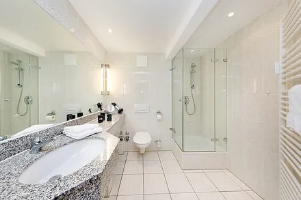 Hier ein Blick in das große Bad mit Echtglasdusche, Fön und WC.