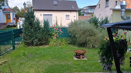 Blick von der Terrasse Feuerstelle und Grillplatz