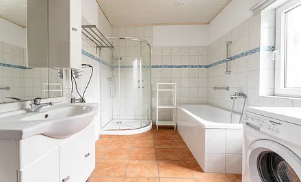 Badezimmer mit Badewanne und Dusche