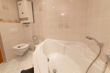 Eck-Badewanne im Bad mit Duschsitz