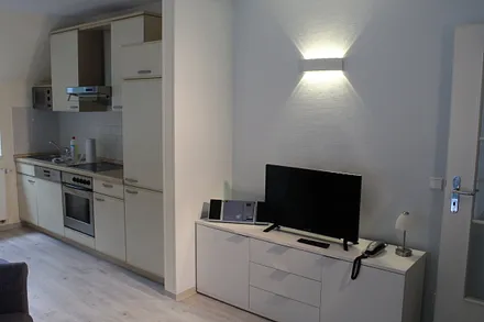 Wohnraum mit Fernseher, CD Player, Telefon und kostenfreiem WLAN