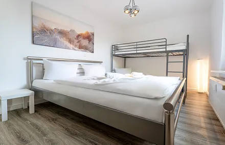 Schlafzimmer mit Doppelbett und Etagenbett