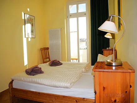 Blick in das Schlafzimmer mit Zugang zum Balkon