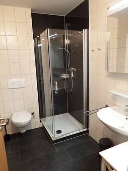 renoviertes Duschbad mit tiefem Einstieg in die Dusch und Fenster