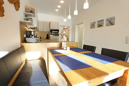 großer Eichenholztisch mit Freischwinger-Stühlen und bequemer Sitzbank