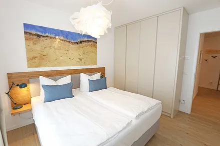 1.  Schlafzimmer mit Doppelbett und Kleiderschrank