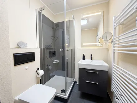 innenliegendes Bad mit Waschbecken, Dusche mit niedrigem Einstieg, WC, Kosmetikspiegel, Handtuchheizkörper