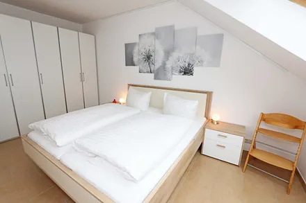 Schlafzimmer mit Doppelbett (1,80 m x 2,00 m), Nachttischablagen, Kleiderschrank sowie einen weiteren Smart-TV welcher aber nur zum Streamen genutzt werden kann