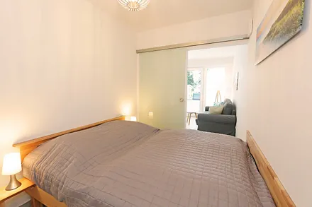 Schlafzimmer mit Doppelbett (1,60 m x 2,00 m), zwei 7-Zonen-Kaltschaummatratzen, Nachttischablagen und Einbauschrank