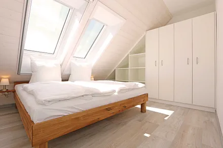 Schlafzimmer mit Doppelbett (1,80 m x 2,00 m), Nachttischablagen, Kleiderschrank und En Suite Badezimmer mit WC, Waschplatz, Fön und Dusche