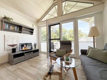 gemütliches Wohnzimmer mit Couch und Smart-TV