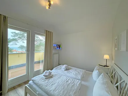 Schlafzimmer mit Doppelbett und Blick zur Ostsee