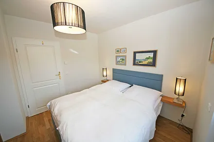 Schlafzimmer mit Doppelbett (1,60 m x 2,00 m), Nachtischkonsolen und Kleiderschrank