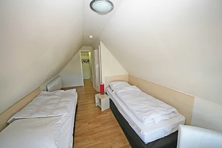 Schlafzimmer (Dachgeschoss) mit 2 Einzelbetten (die auch als Doppelbett gestellt werden können), begehbarer Kleiderschrank, verdunkelbare Plissee