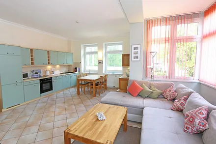 Wohnbereich mit Couch (Ausziehfunktion zum Doppelbett (1,60 m x 2,00 m), Kleiderschrank, Sessel, Couchtisch, kleinem Beistelltisch, Flachbild-TV, DVD-Player sowie Mini-Stereo-Anlage mit USB-Anschluss