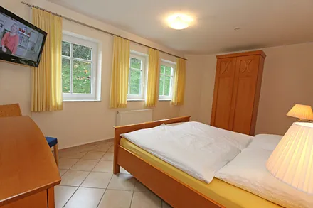 Schlafzimmer mit Doppelbett (1,80 m x 2,00 m), verstellbare Lattenroste, 2 Nachtschränken, Flachbild-TV und Kleiderschrank 