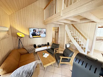 Wohnbereich mit gemütlicher Couch, zwei Sessel, Leselampe, Smart-TV, Blu-Ray-Player, Mini-Stereo-Anlage mit DAB-Radio