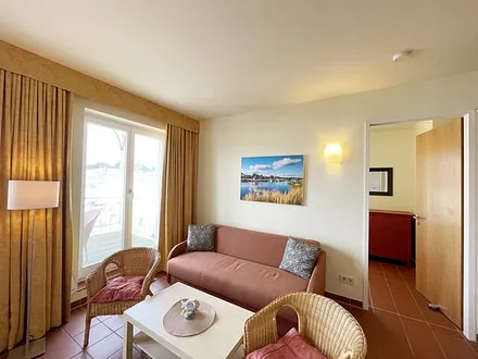 Wohnbereich mit komfortabler Schlafcouch (1,60m x 1,95m), Leselampe und LED Fernseher