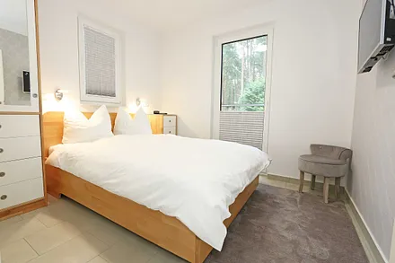 1. Schlafzimmer mit Doppelbett und TV