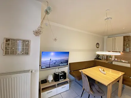 Wohnbereich mit bodentiefen Fenstern, 3-Sitzer-Couch, Couchtisch, Smart-TV, DVD-Player, Radio mit CD-Player und USB-Anschluss sowie eine Alexa-Box