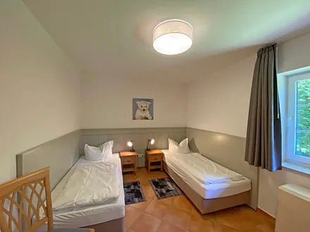 Schlafzimmer mit 2 Einzelbetten (0,90 m x 2,00 m), auch als Doppelbett stellbar, Nachttischablagen und Kleiderschrank 
