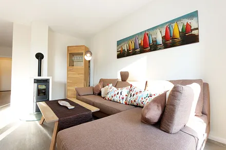 Wohn-/Küchenbereich mit hochwertigen Massivholzmöbeln, Couch ( Aufbettung für 3. Person 0,90 m x 2,00 m), Couchtisch, Leselampe, Kamin Pelletofen, TV-Board mit Smart-TV sowie eine Bose Soundbar