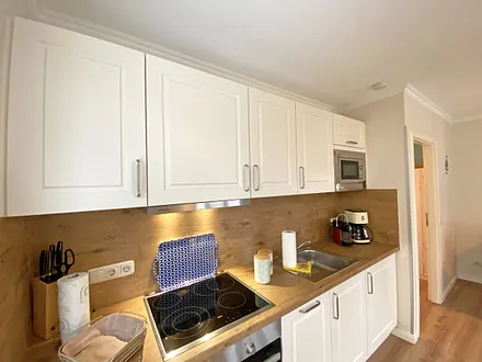 offene Küchenzeile mit Kühlschrank und Gefrierfach, Geschirrspüler, 4 Zonen Ceranfeld, Backofen, Mikrowelle, Kaffeemaschine, Nespresso Kapsel-Maschine, Toaster und Wasserkocher