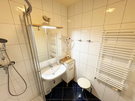 innenliegendes Badezimmer mit Dusche, Fön, WC sowie einen Waschplatz