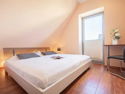 Das zweite Schlafzimmer mit Doppelbett und kleinem Schreibtisch