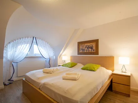 Das erste Schlafzimmer mit Doppelbett in der unteren Etage
