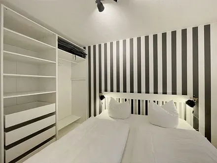 Schlafzimmer mit Doppelbett (1,80 m x 2,00 m), Wand-Nachttischlampe, verstellbare Lattenroste, Insektenschutzgitter sowie ein geräumiger und offener Kleiderschrank