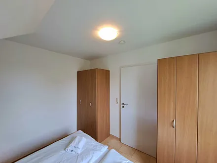 Schlafzimmer mit Doppelbett und Kleiderschrank