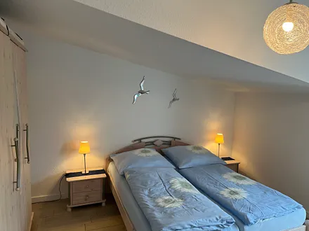 FW2, Schlafzimmer mit TV und Zugang auf den Balkon