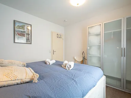 Das Schlafzimmer mit Doppelbett und Kleiderschrank