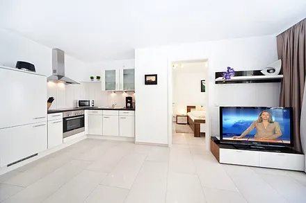 Der Wohnbereich mit Blick auf die Küchenzeile und ins Schlafzimmer.