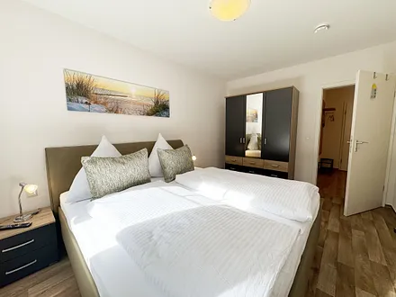 Schlafzimmer mit Doppelbett und Nachttischablagen