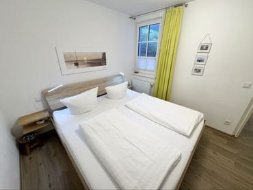 Schlafzimmer mit Doppelbett und Nachttischablagen