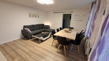 Wohnzimmer mit Schlafcouch und Essbereich