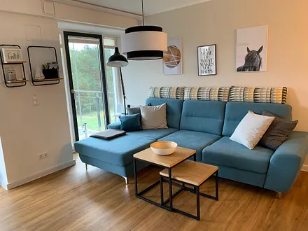 offener Wohnbereich mit Couch, Couchtisch und Stehlampe