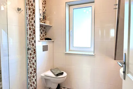 Das Bad mit einem Stück Dachschräge, schönen Vintagefliesen ...