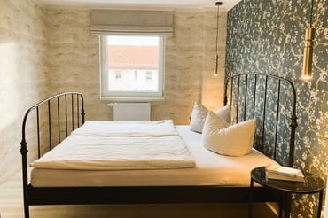 Das Schlafzimmer mit einem Raffrollo mit Verdunkleungsfuntion ...