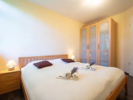 Das erste Schlafzimmer mit Doppelbett und großem Kleiderschrank