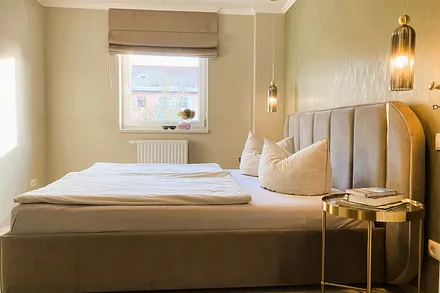 Das schöne Schlafzimmer hat ein Raffrollo mit Verdunkelungsfunktion.